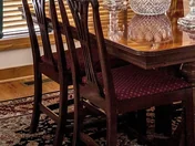 Dining chairs along one side of the table